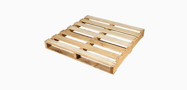A wooden pallet is sitting on a white surface.