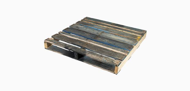 A wooden pallet with a plastic handle on a white background.