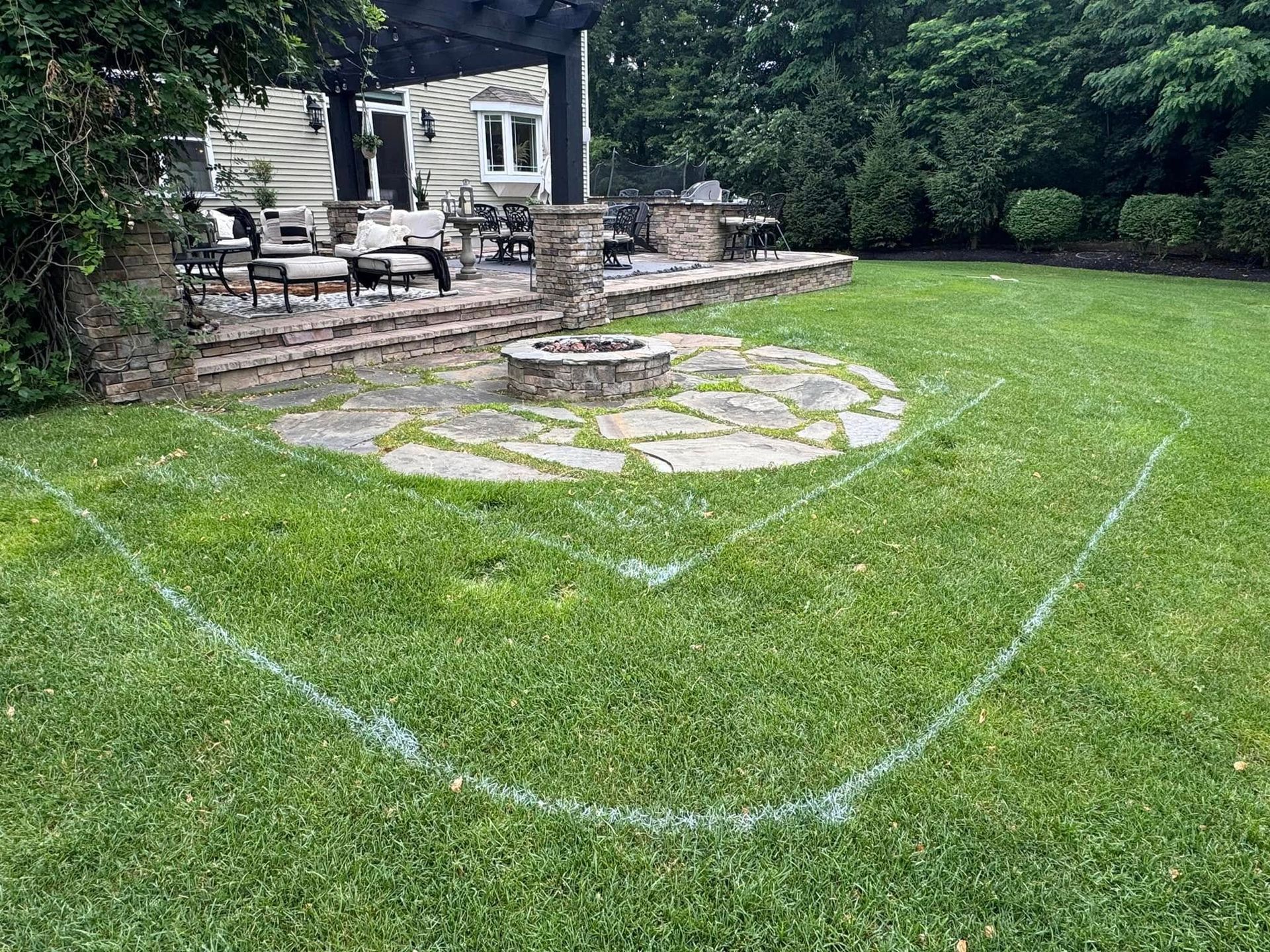 There is a fire pit in the middle of the yard.
