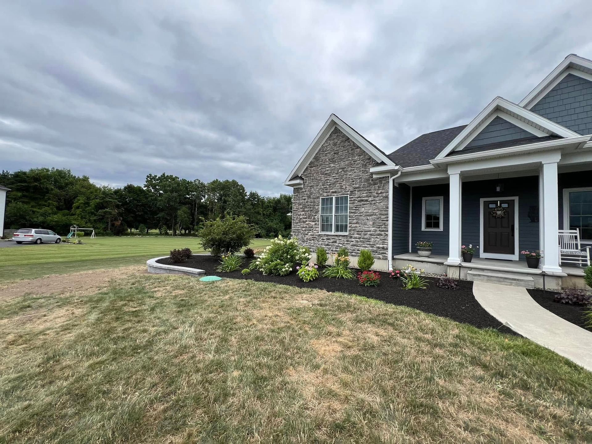 A large house with a large lawn in front of it.