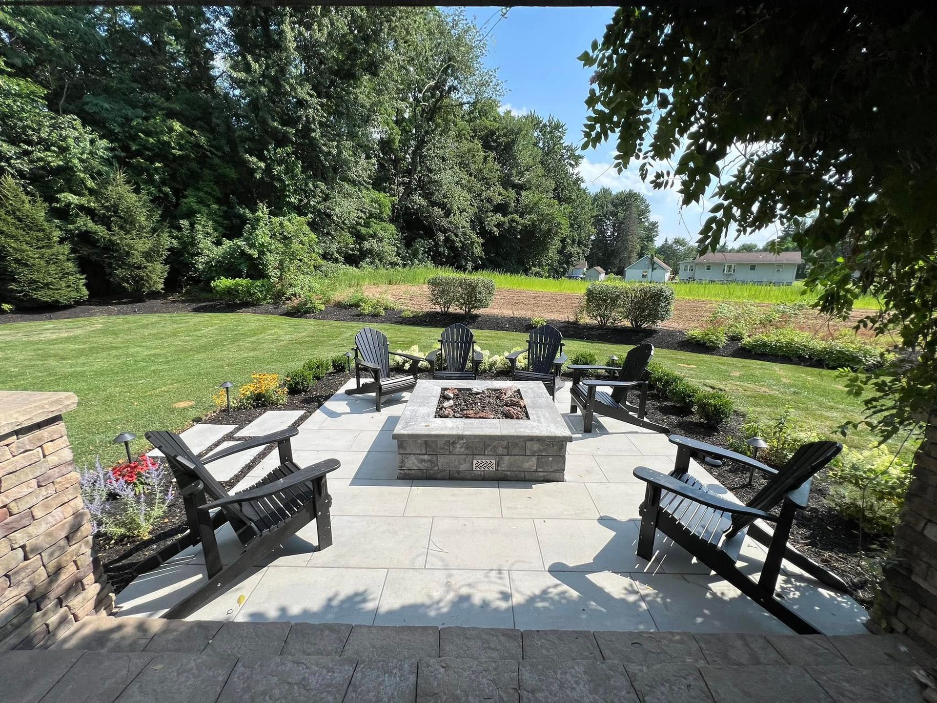 There is a fire pit in the middle of the patio.