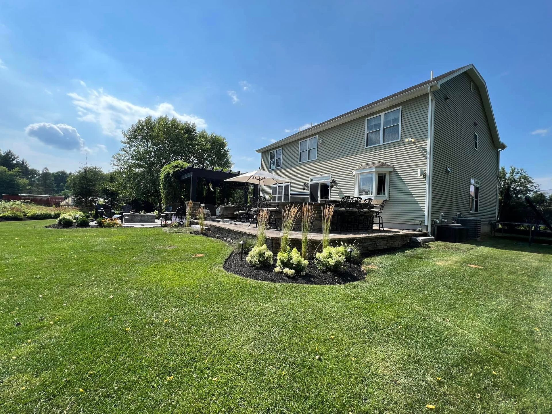 A large house with a large lawn in front of it.