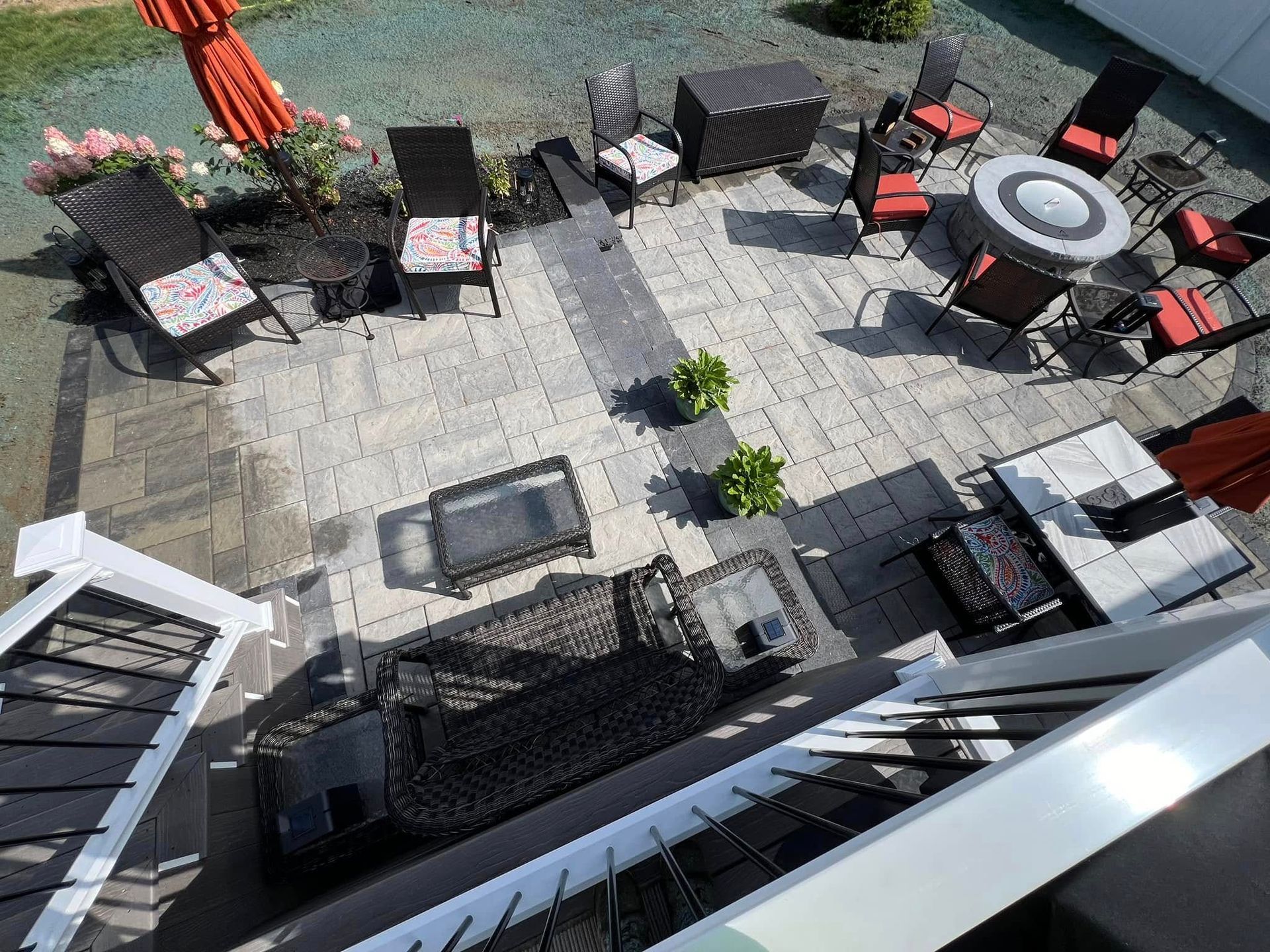 An aerial view of a patio with chairs , tables and umbrellas.