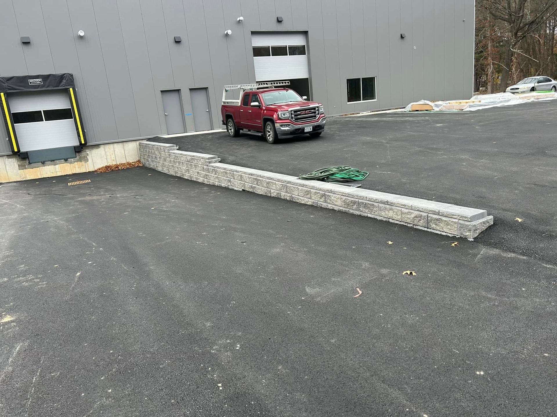 A red truck is parked in front of a building
