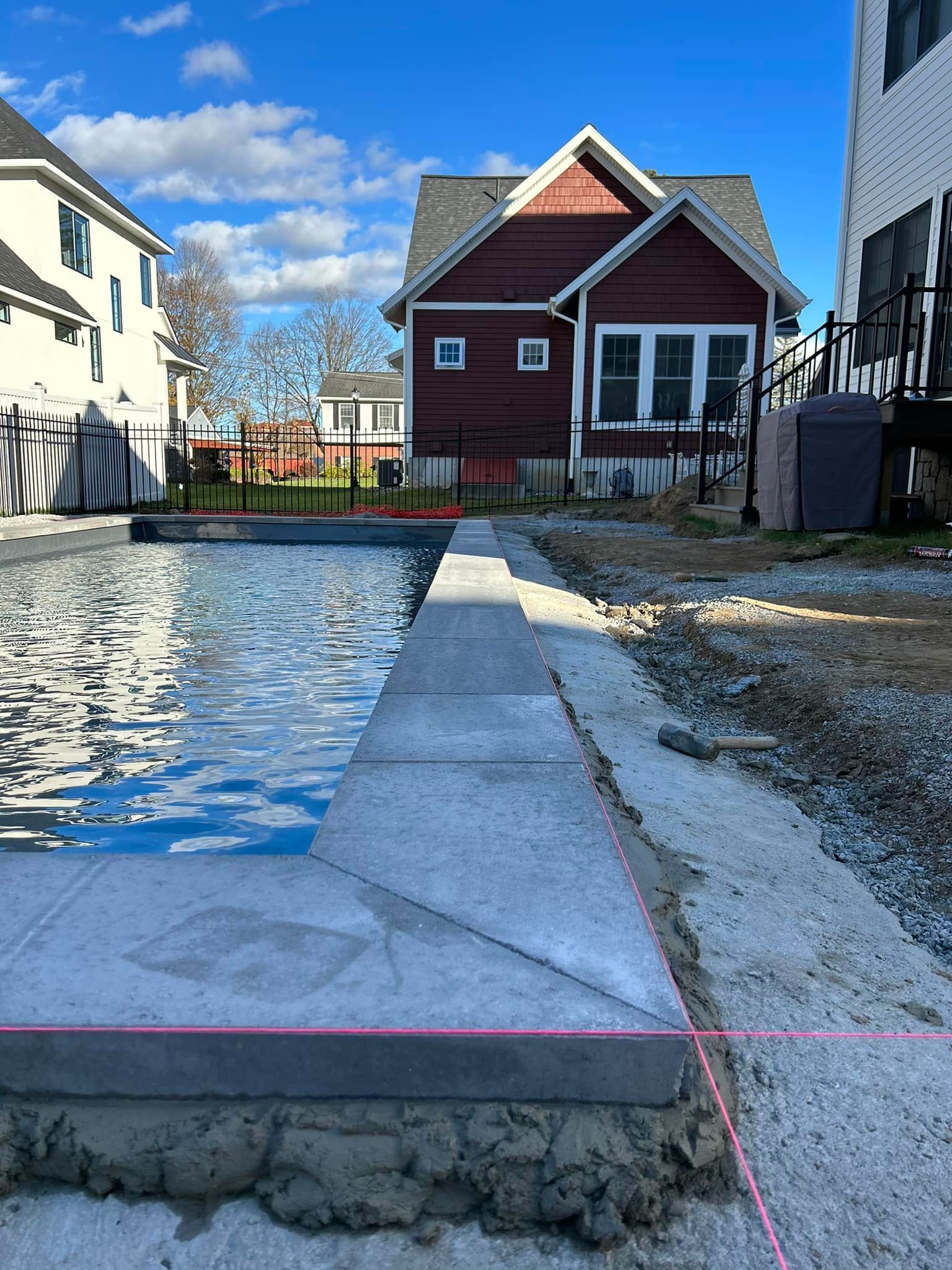 A swimming pool is being built in front of a house.