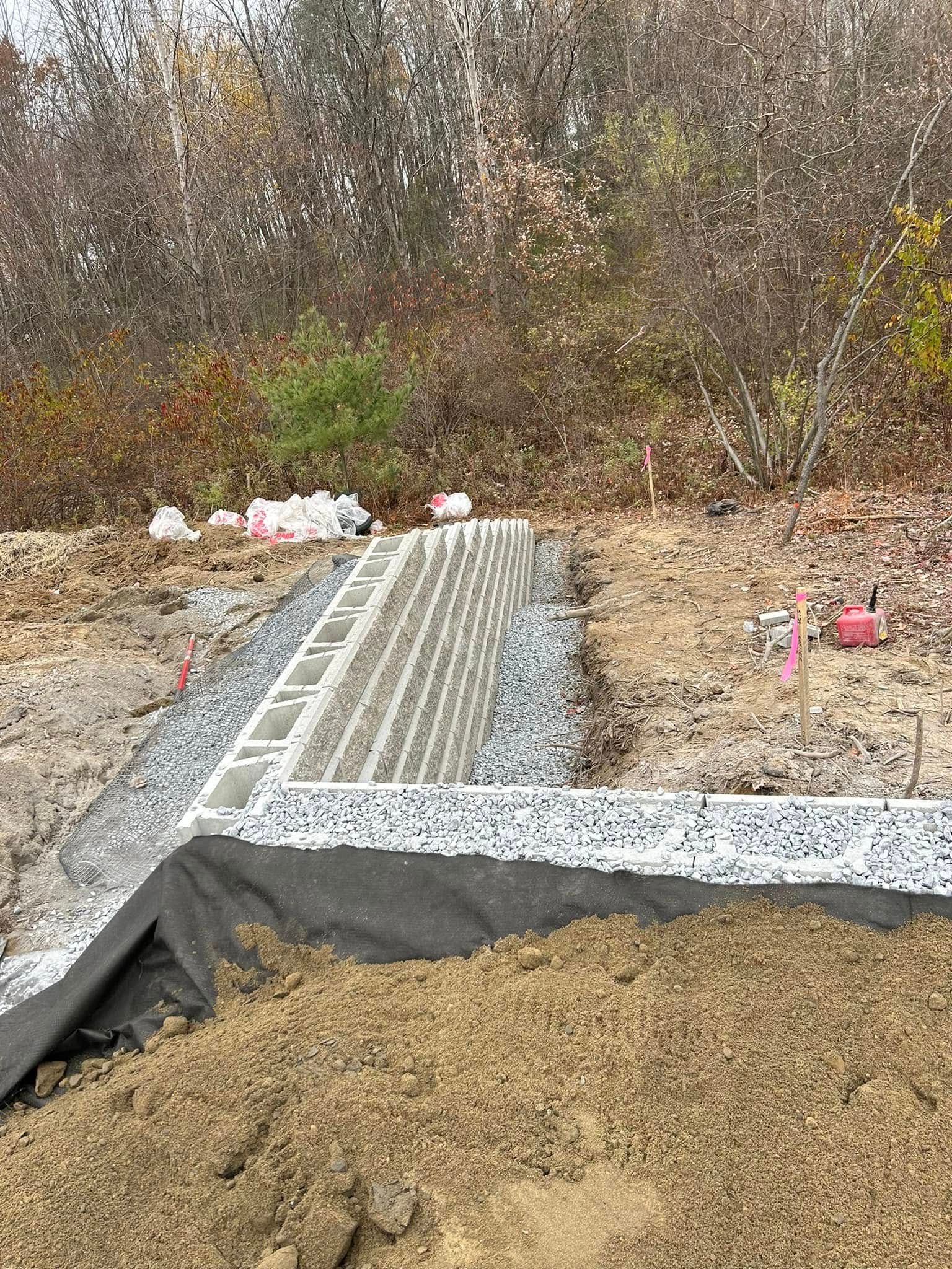 A pile of dirt and gravel is sitting on top of a dirt field.