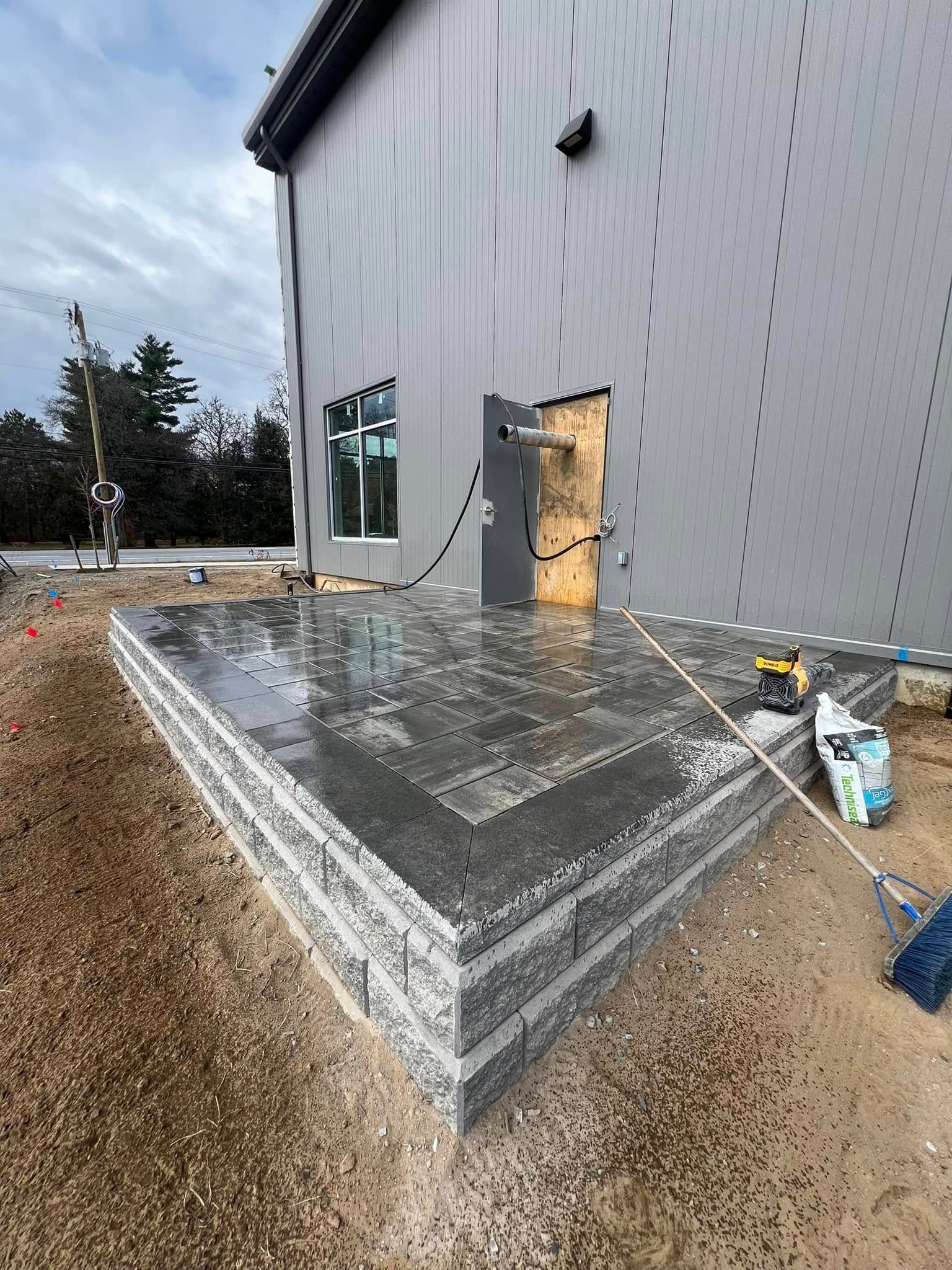 A concrete patio is being built in front of a building.