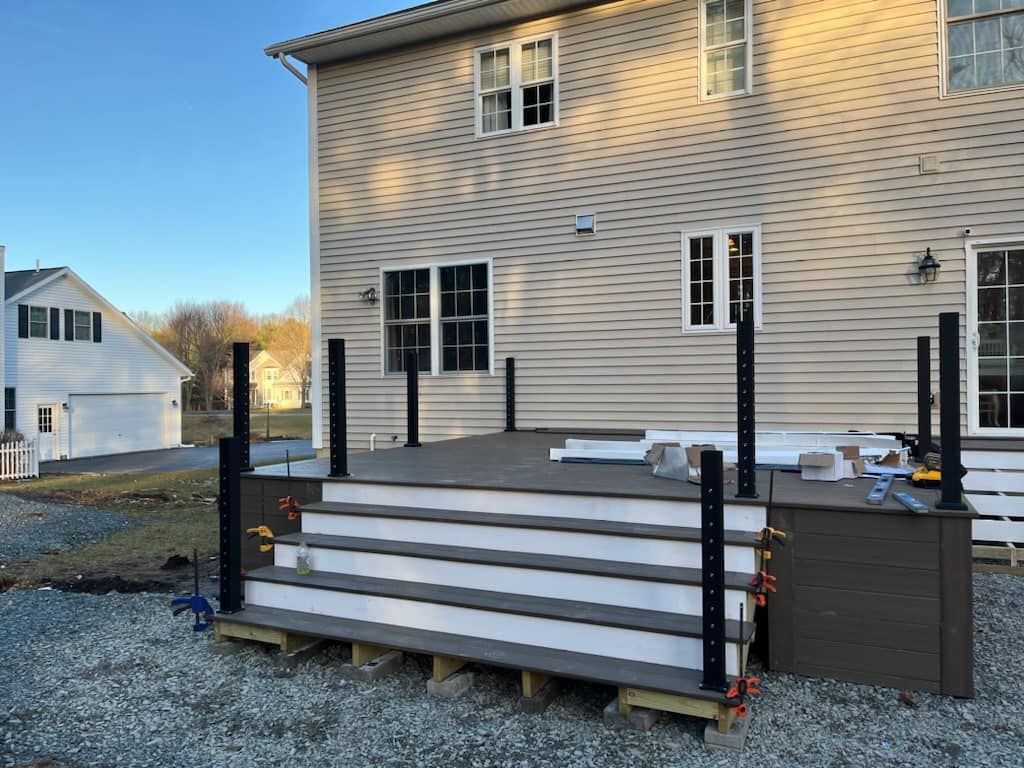 A deck is being built in front of a house.