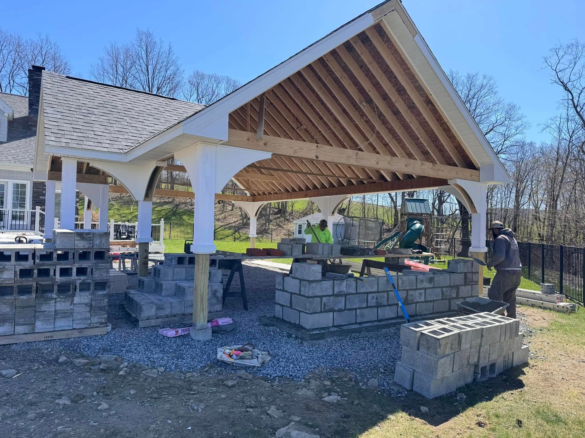 A pavilion is being built in the backyard of a house.