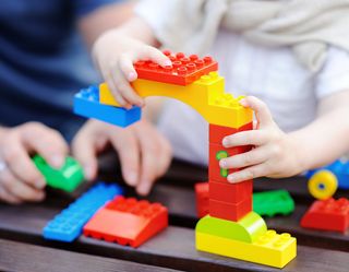 Infant Care — Infant Playing Lego in Mentor, OH