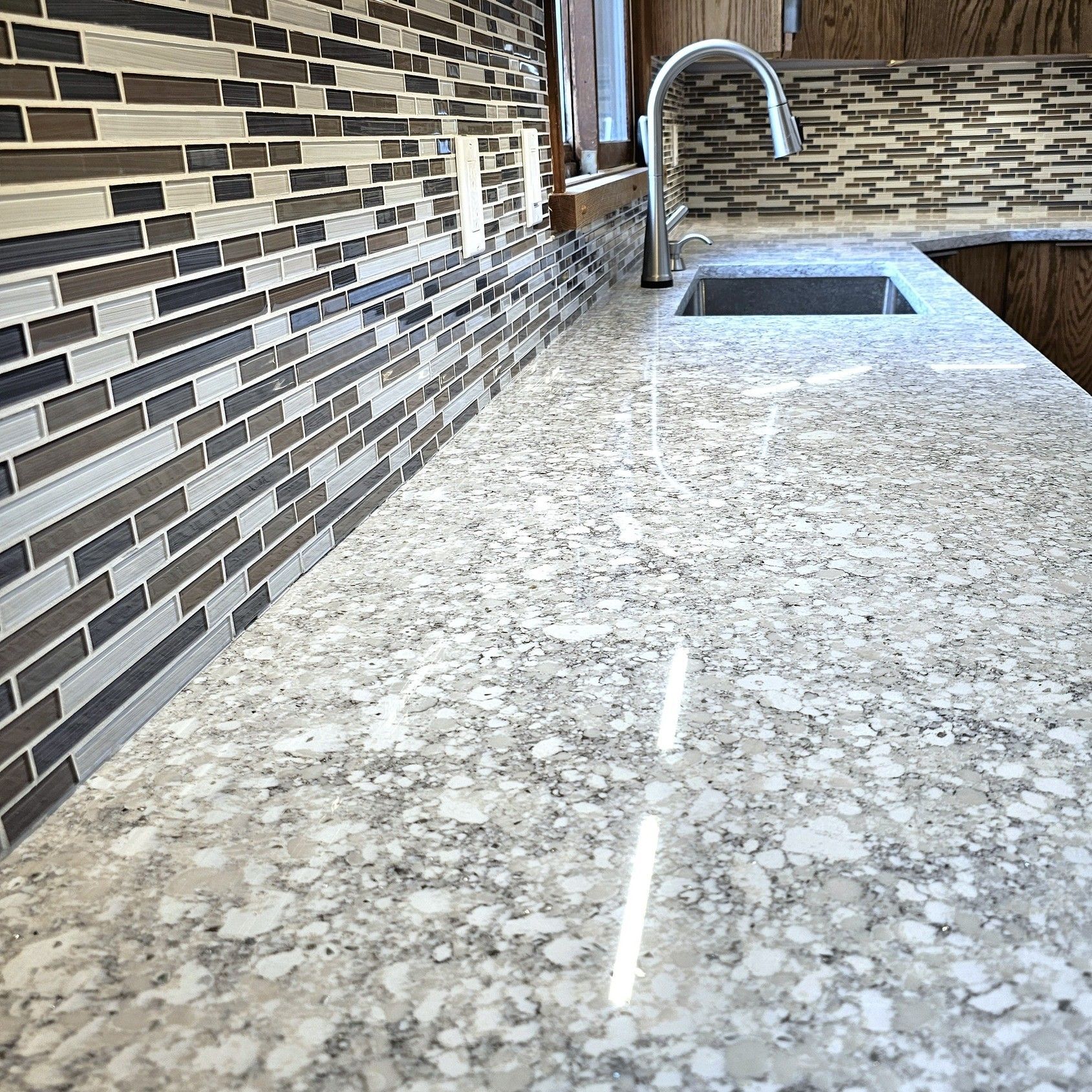 A kitchen counter with a sink and a faucet.