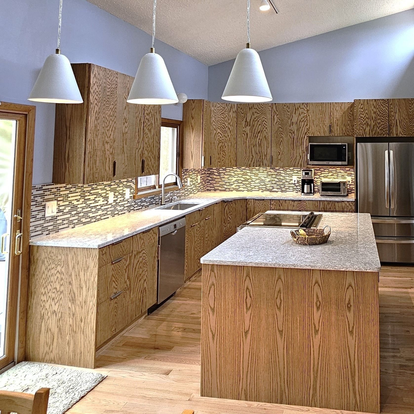 A kitchen with wooden cabinets and stainless steel appliances