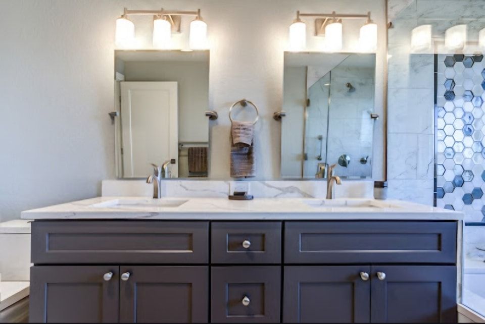 A bathroom with two sinks and two mirrors.