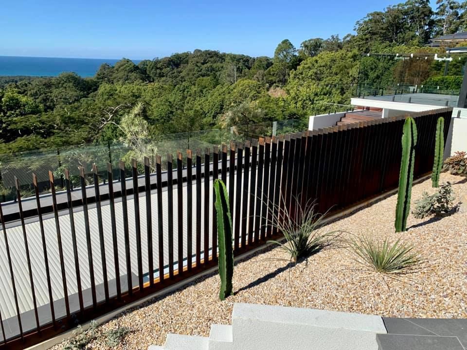 A Black Fence With a View of the Ocean and Trees β Swift Glass & Aluminium In Woolgoolga, NSW
