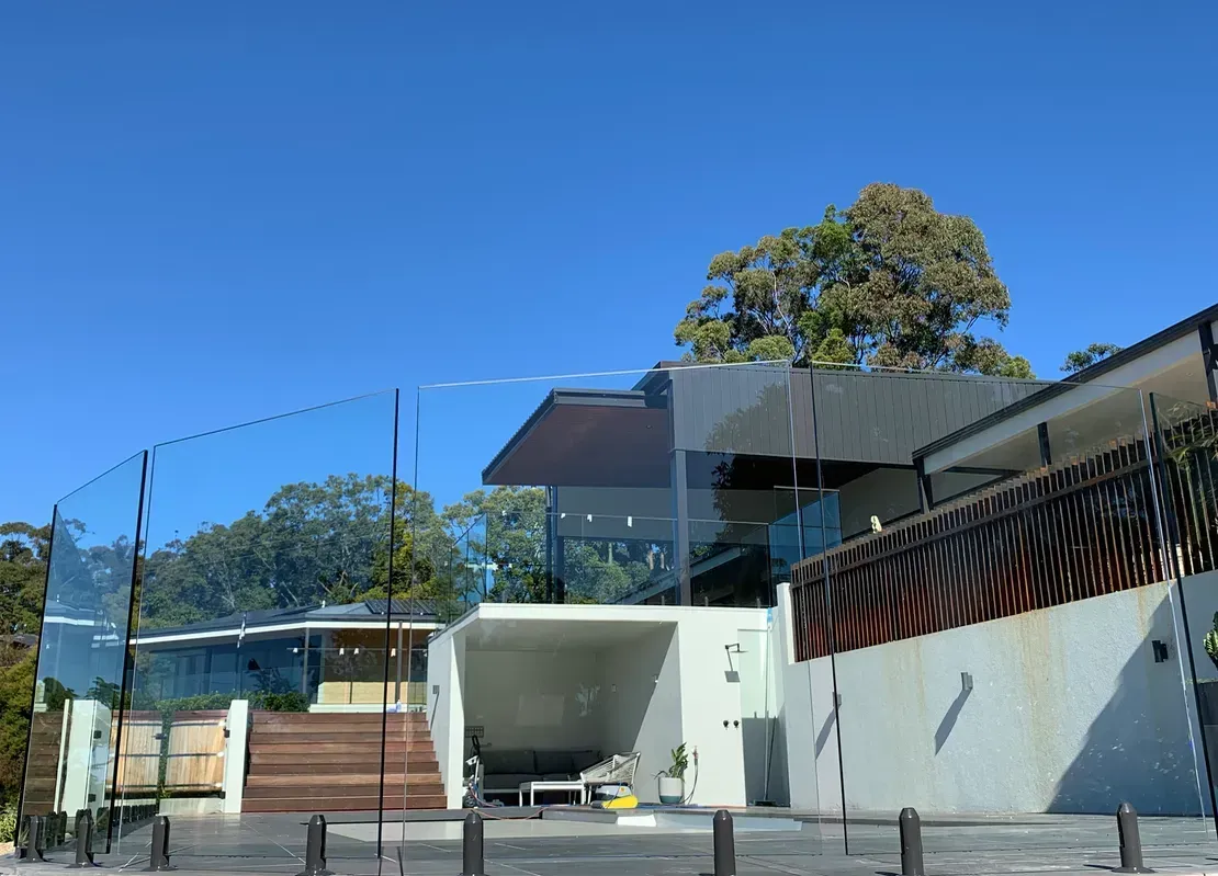 A Large House With a Glass Railing and Stairs is Sitting on Top of a Hill β Swift Glass & Aluminium In Woolgoolga, NSW