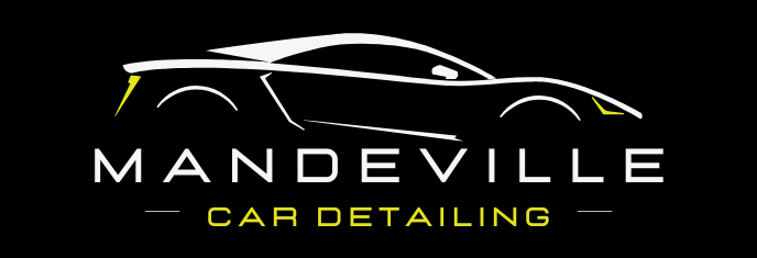 A logo for mandeville car detailing  with a yellow car on it.