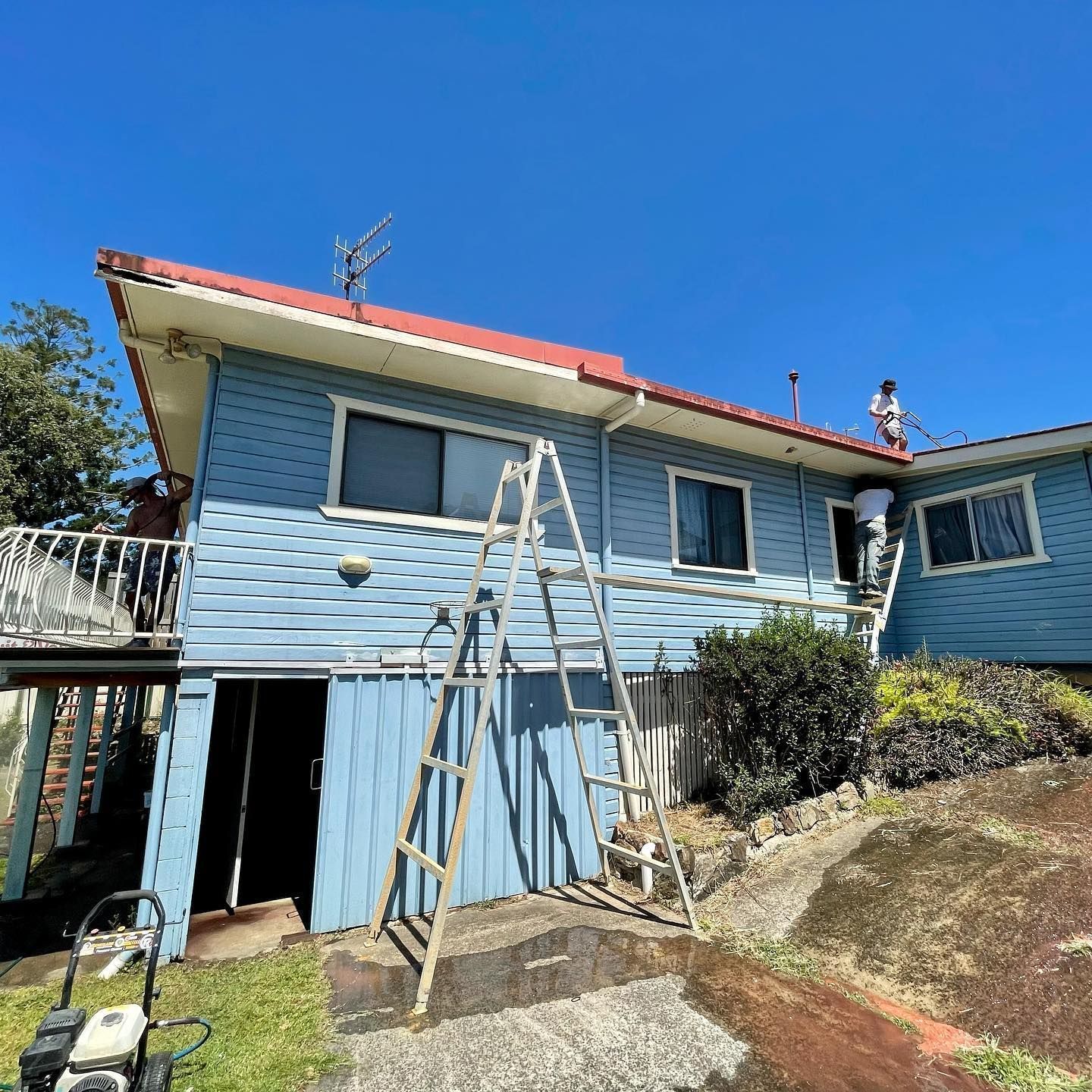 A Blue House With Red Roof, Workers on Ladder and Roof — All Coast Painting in Tweed Heads South, NSW