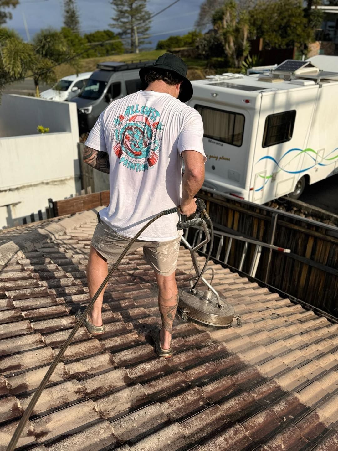 Man Power Washing a Terracotta Tile Roof, Outdoors on A Sunny Day — All Coast Painting in Tweed Heads South, NSW