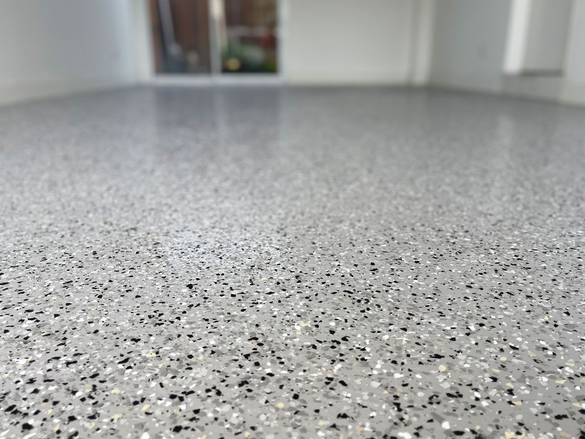 Close-up of a Speckled, Gray Epoxy Floor, Reflecting Light — All Coast Painting in Tweed Heads South, NSW