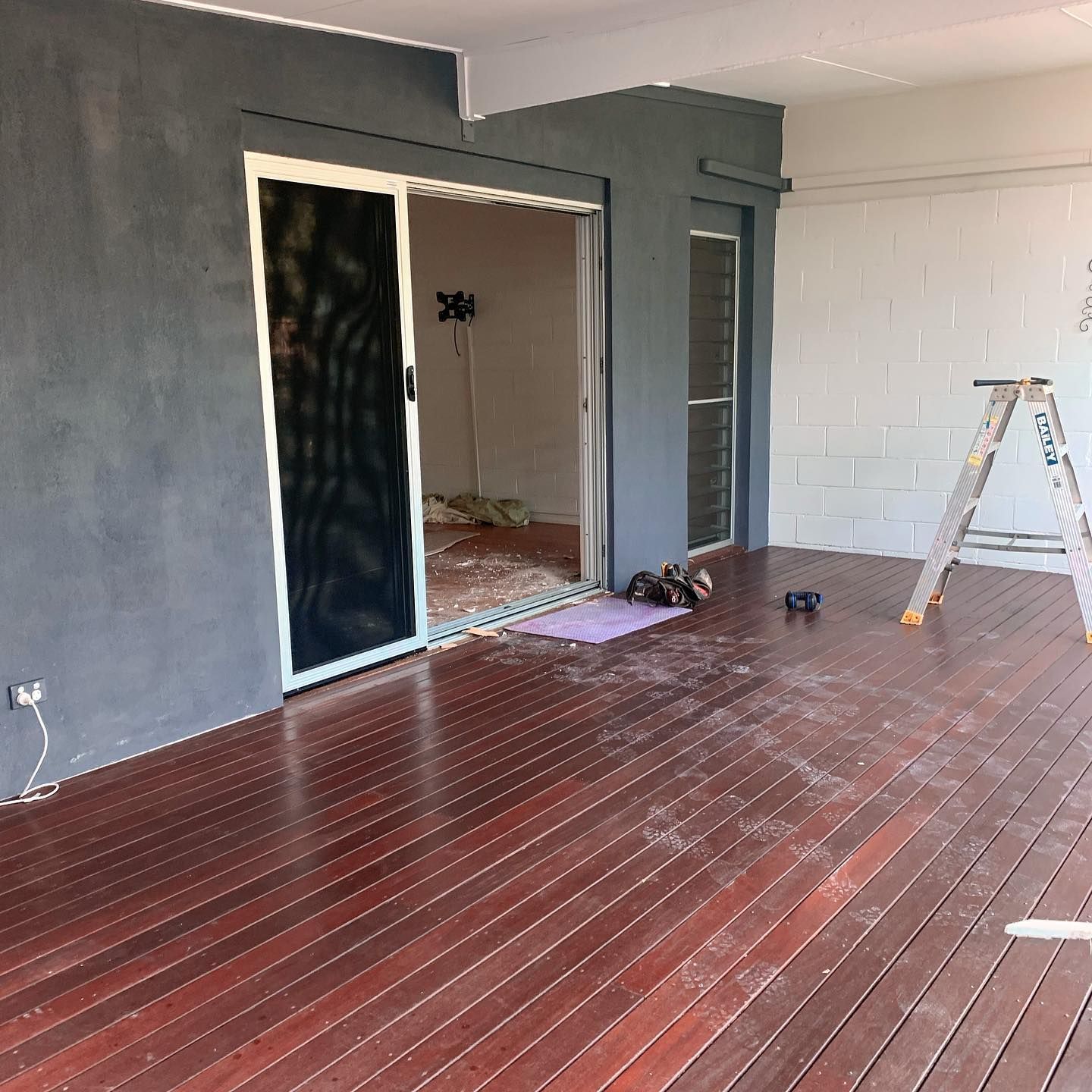 A Dark Wood Deck With Open Sliding Door and Gray Painted Walls — All Coast Painting in Tweed Heads South, NSW