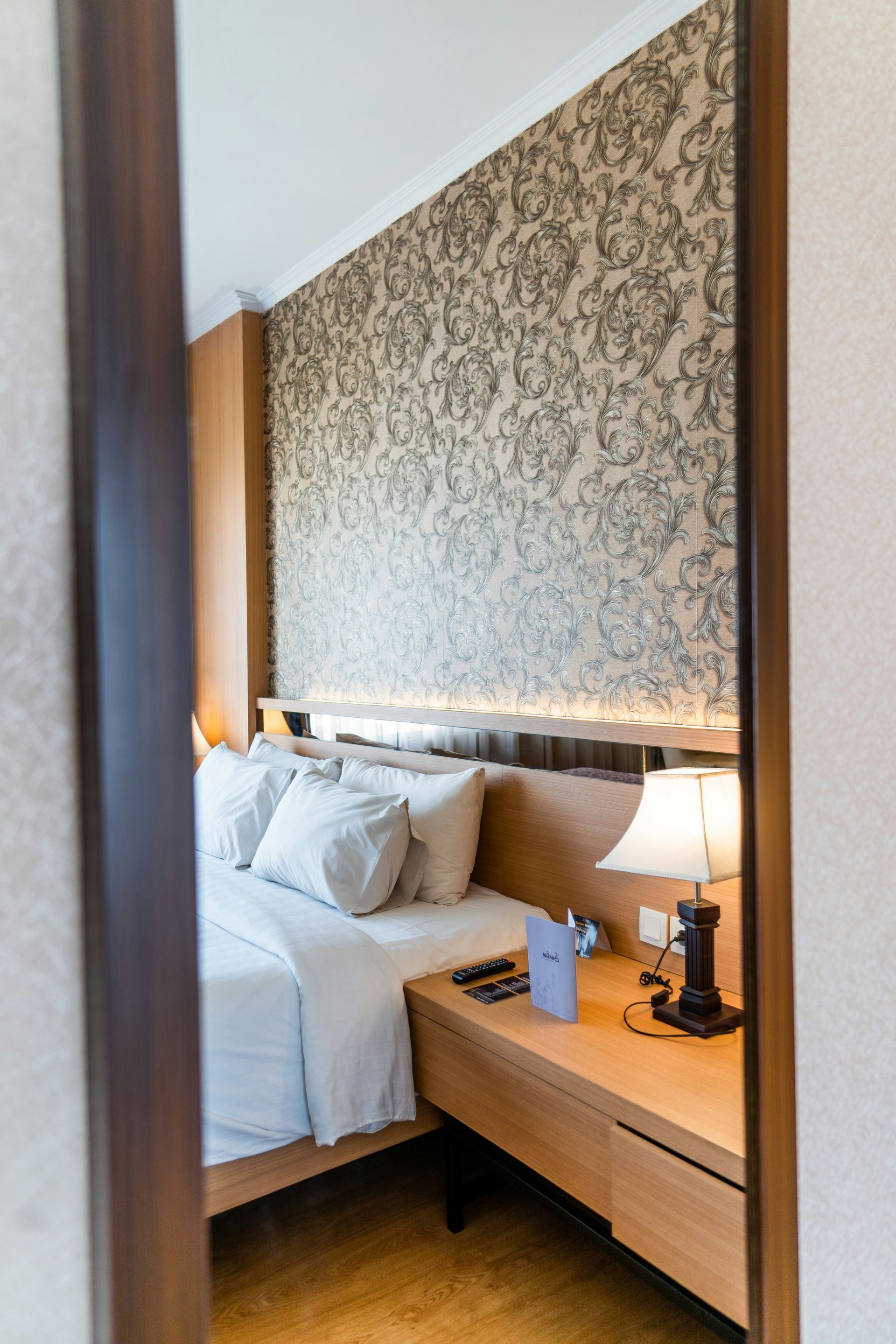 A Mirror Reflecting a Hotel Bedroom Bed — All Coast Painting in Tweed Heads South, NSW