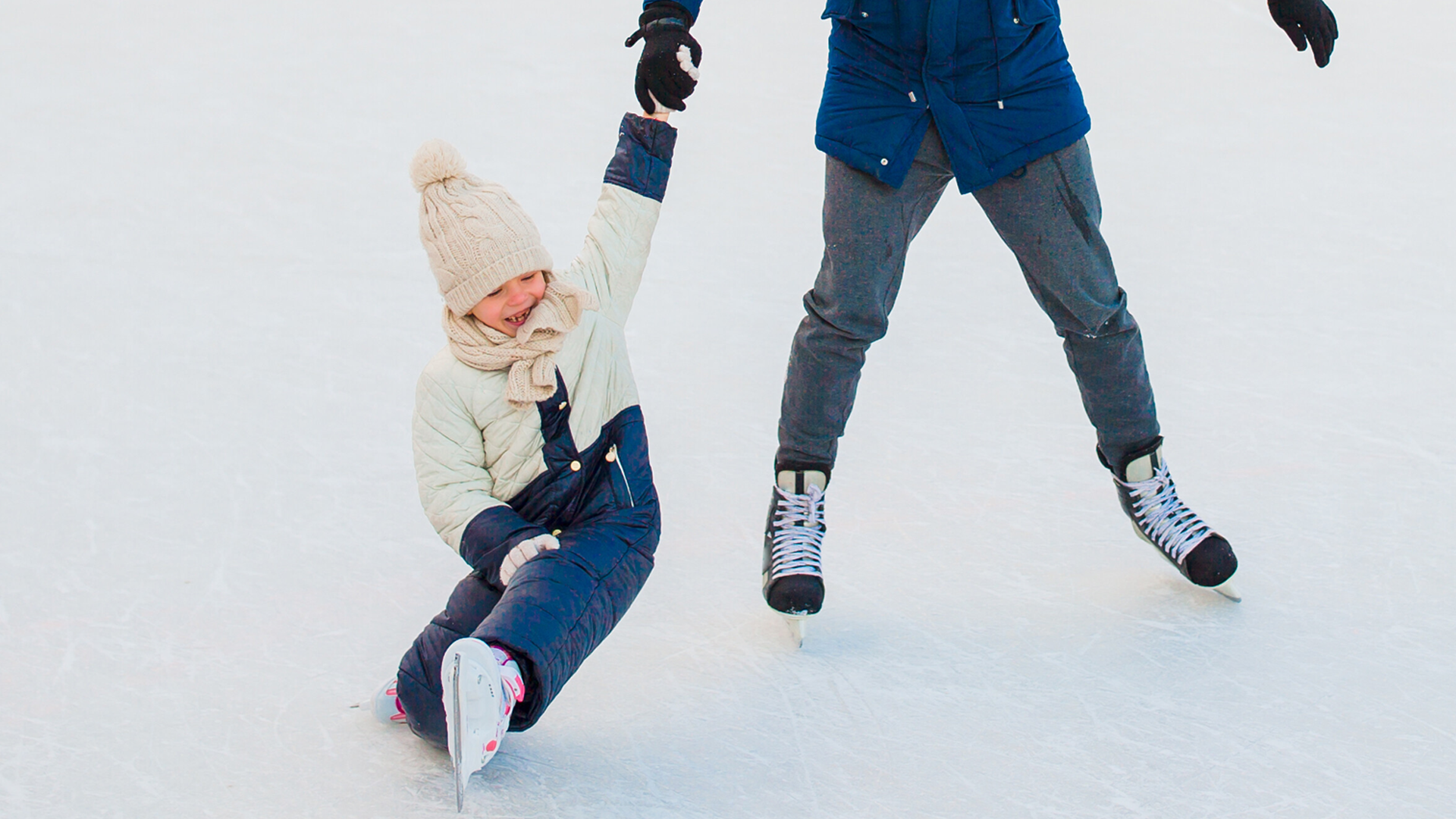 Muskoka family skate shows girl and father enjoying  winter sports outside.