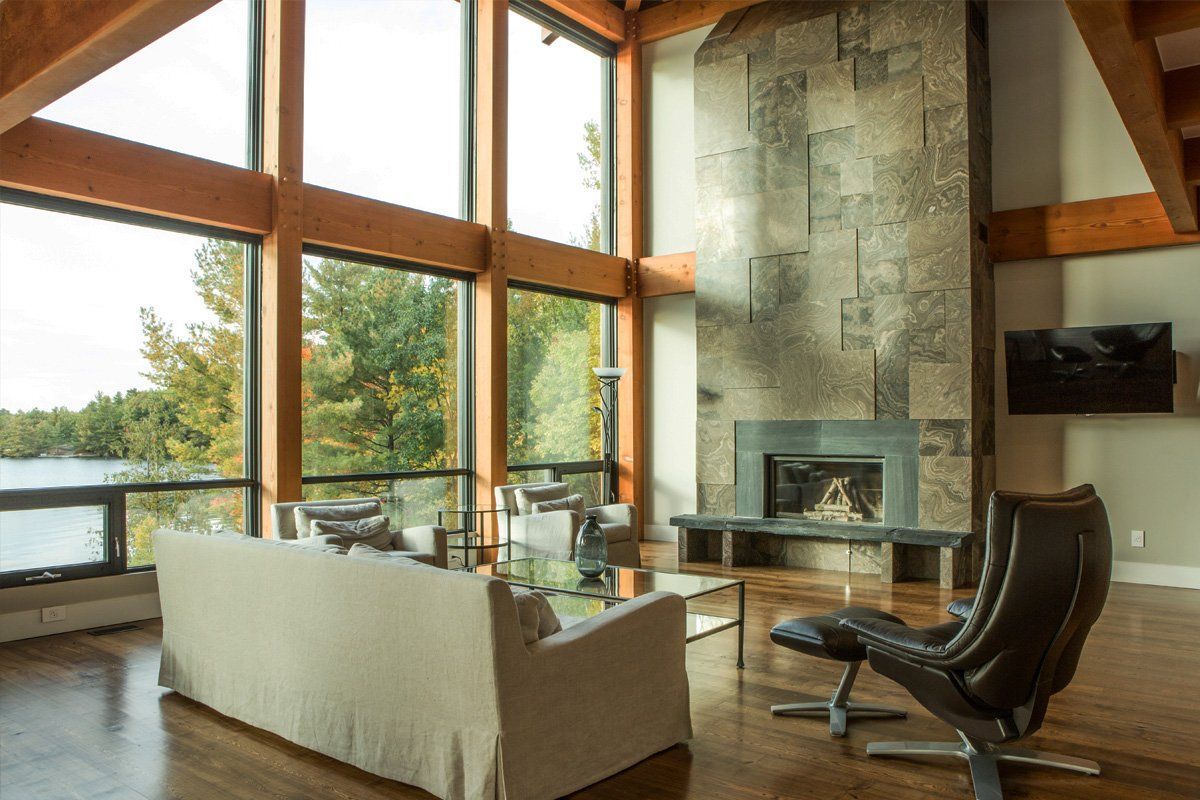 Large, main floor of a cottage with huge windows, a great view and a soaring fireplace.