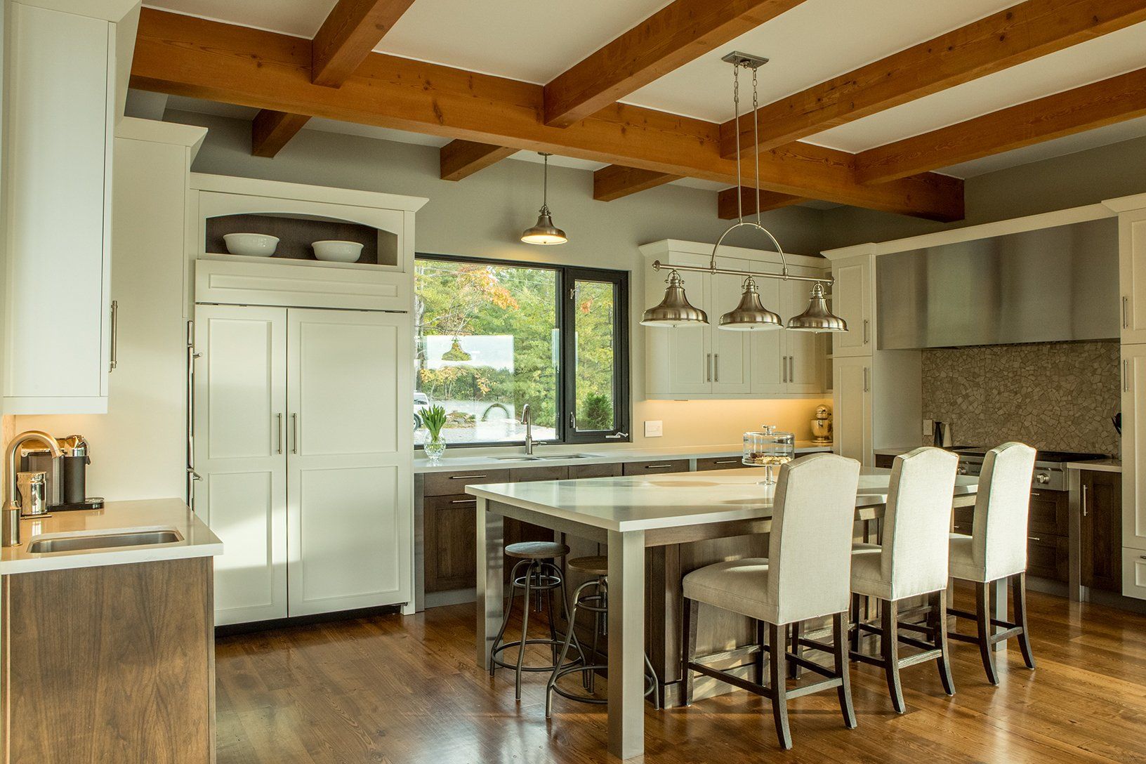 In this CedarCoast home a bright, expansive kitchen features a vaulted ceiling with ample seating at the island.