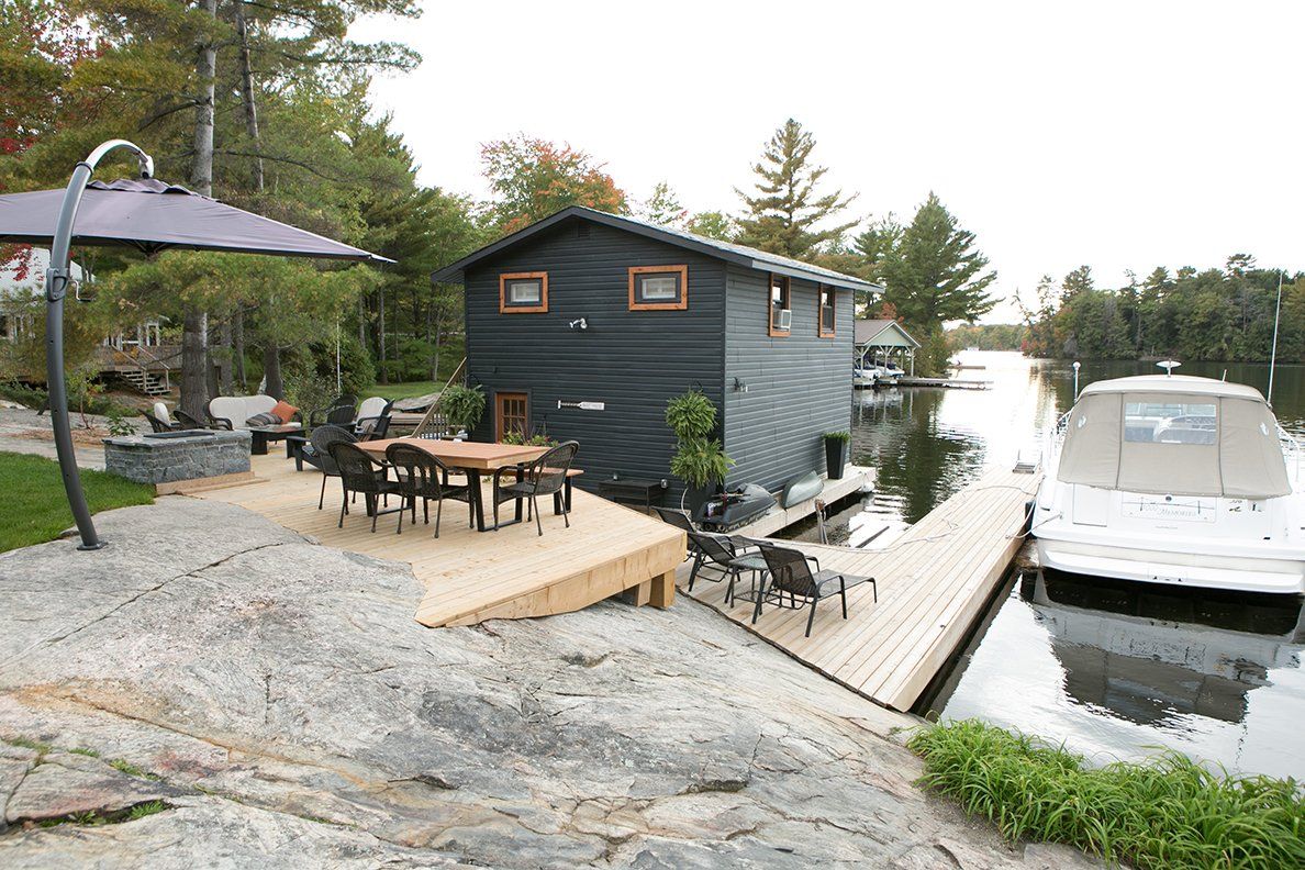 CedarCoast gently sets this walkout home on a sloping rocky landscape.