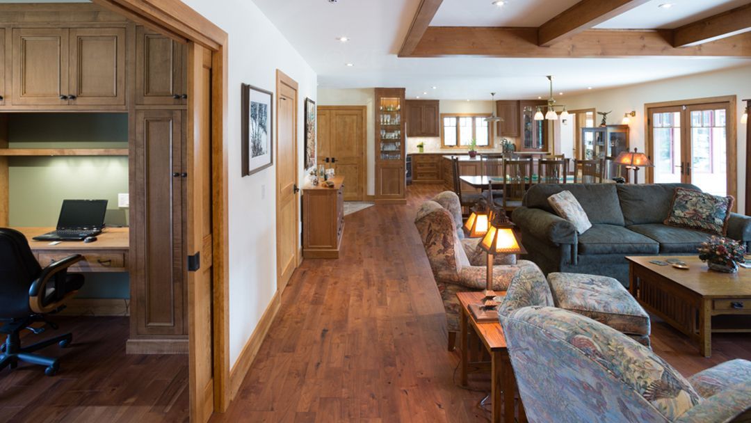 Wood floors and trim in a very wide hallway in a CedarCoast fully accessible home.
