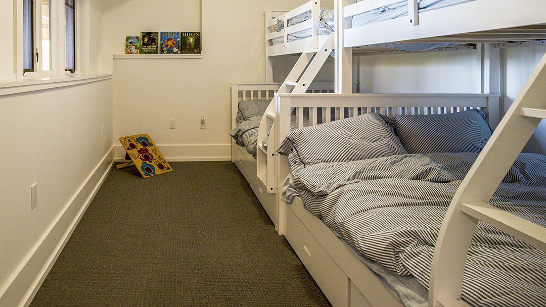 4 bunk beds in a cottage with steps to the upper beds