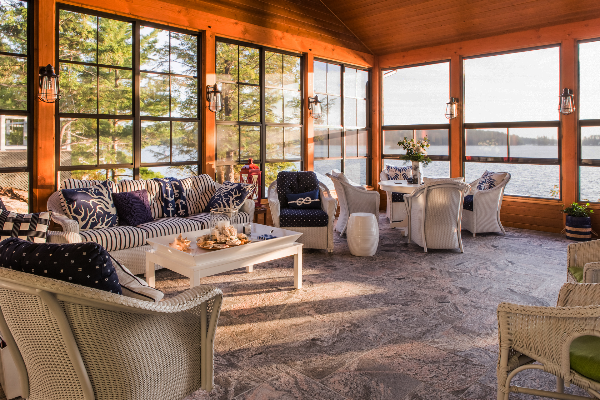Large windows surround a sunny porch with nautical  stylings.