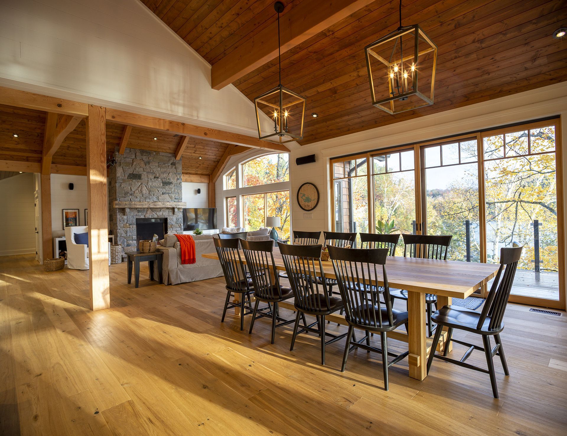 Large windows and wood beams in a Muskoka cottage design.
