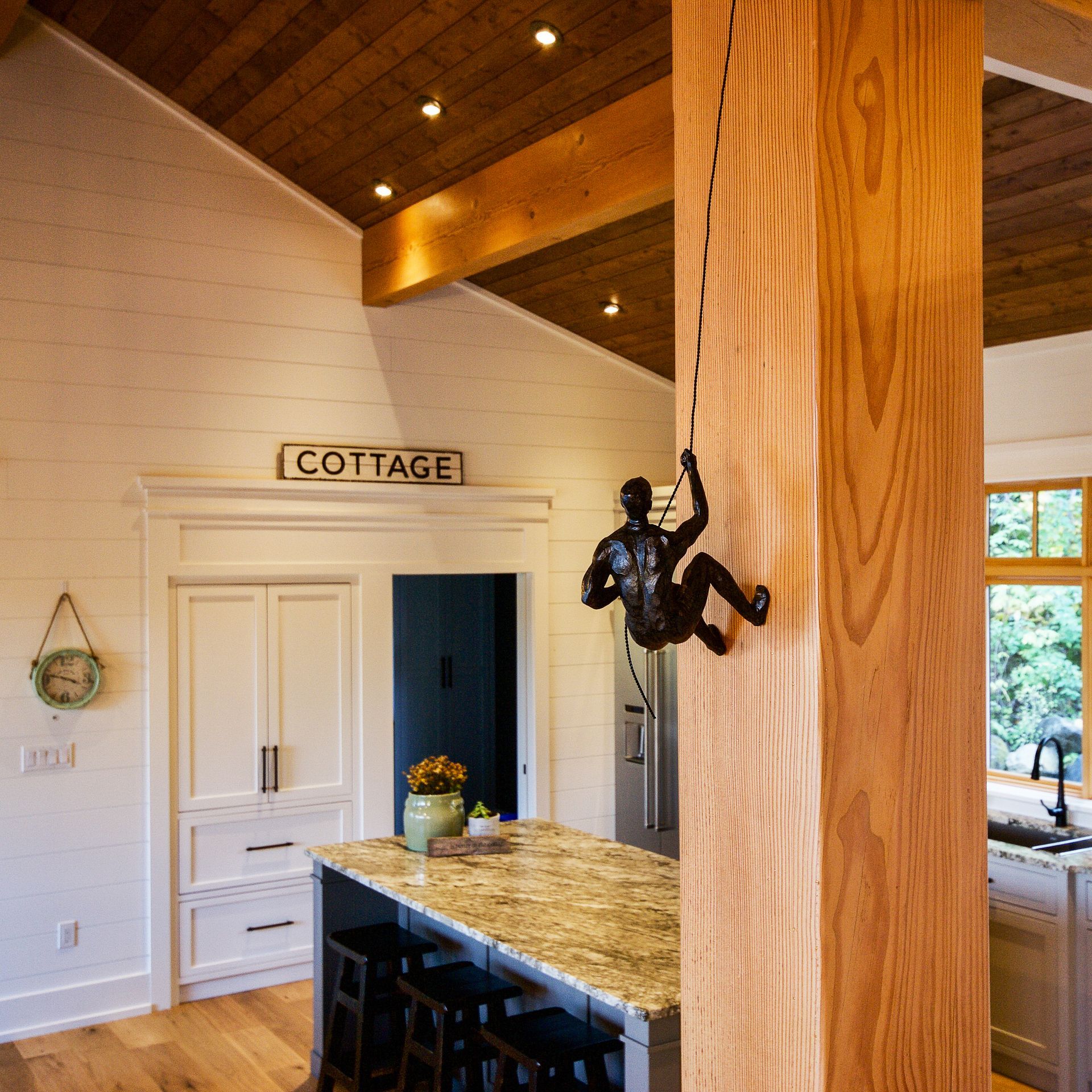 Sloped wood ceiling and visible timber posts in a Muskoka Cottage.