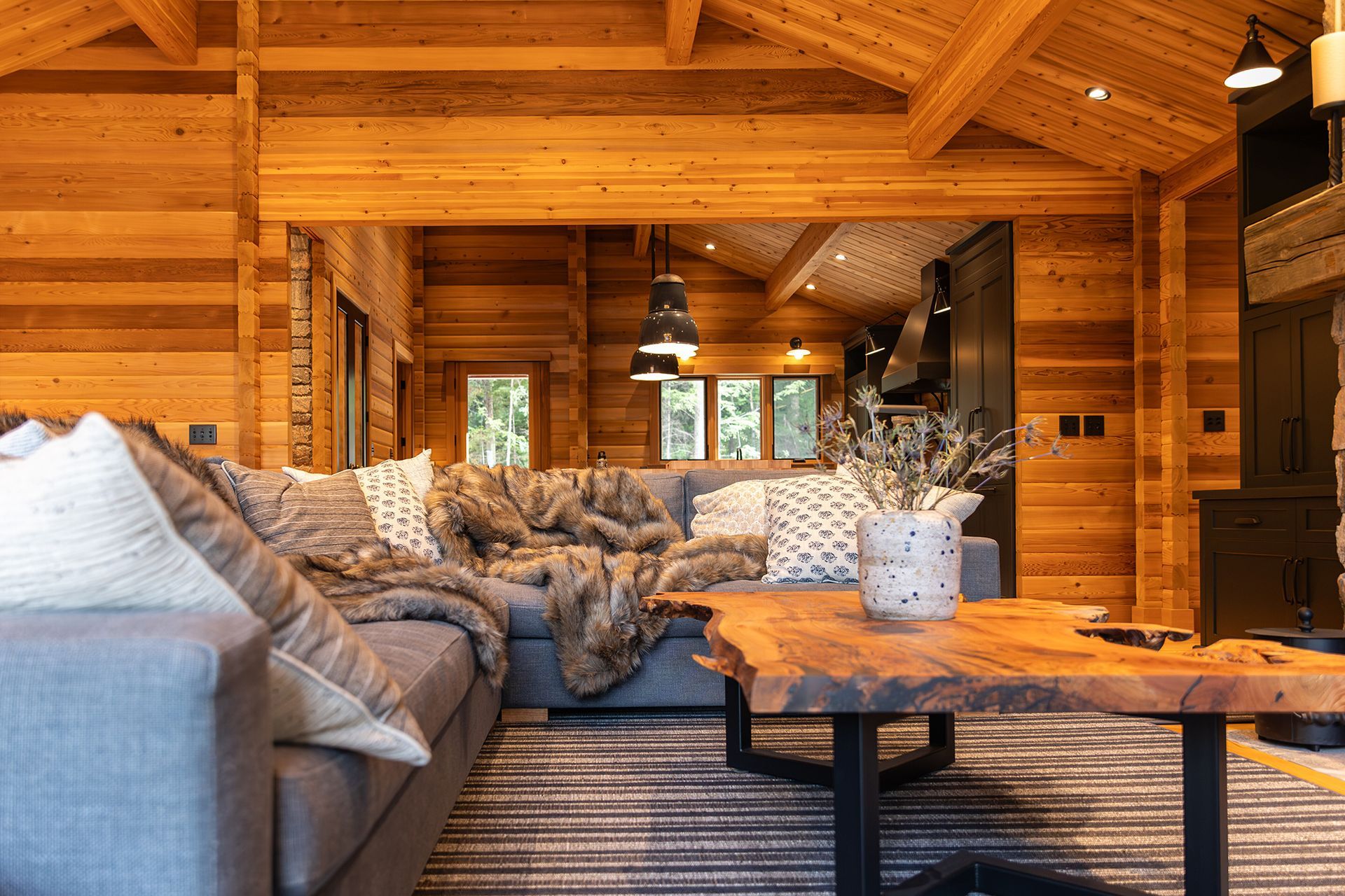 Sectional couch with comfortable throws and pillows in a cedar cottage.