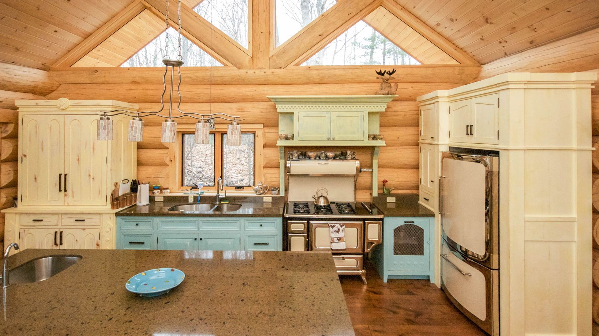 Log cabin kitchen with unique heritage inspired appliances.