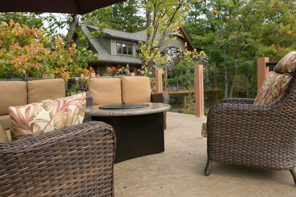 Custom Muskoka Cottage featuring a  patio with wicker furniture and a fire pit