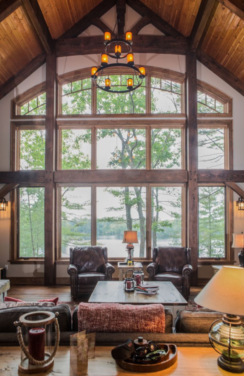 Custom Muskoka Cottage featuring a  living room with a lot of windows and a chandelier