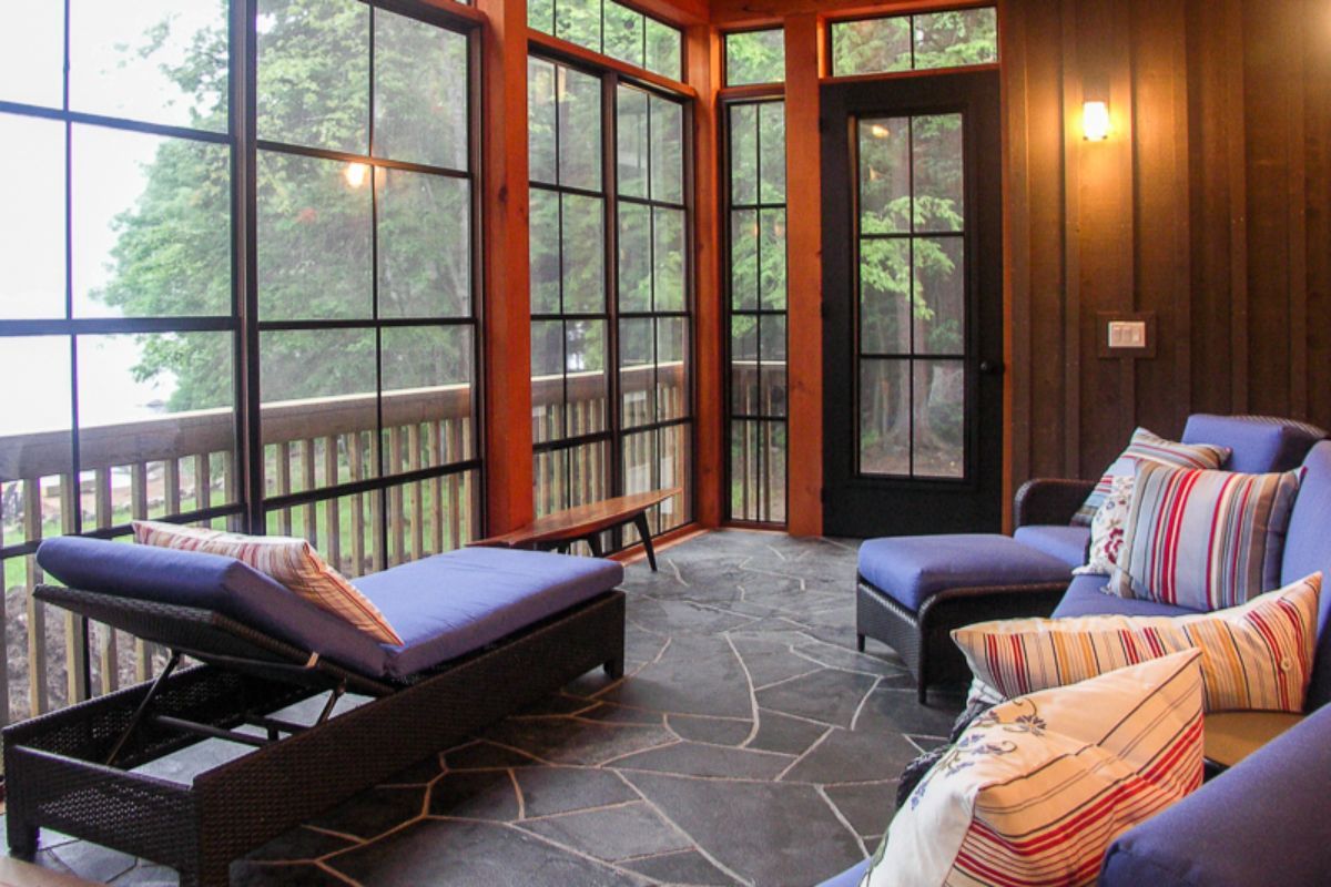 Custom Muskoka Cottage featuring a  screened in porch with a couch and chairs