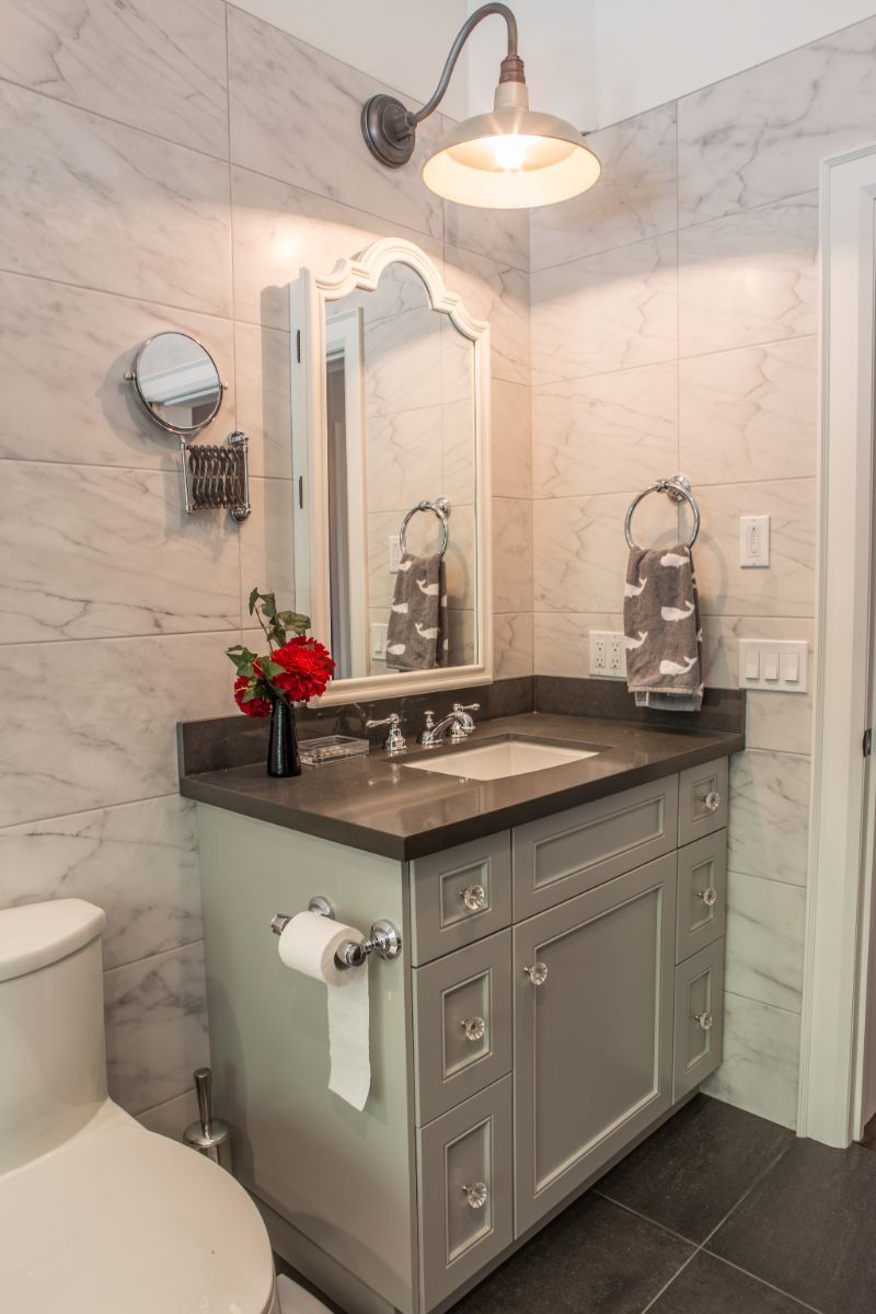 Custom Muskoka Cottage featuring a bathroom with a sink , toilet and mirror.