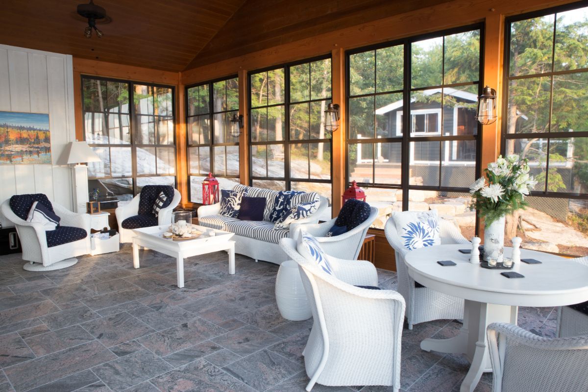 Custom Muskoka Cottage featuring a  living room filled with furniture and lots of windows.