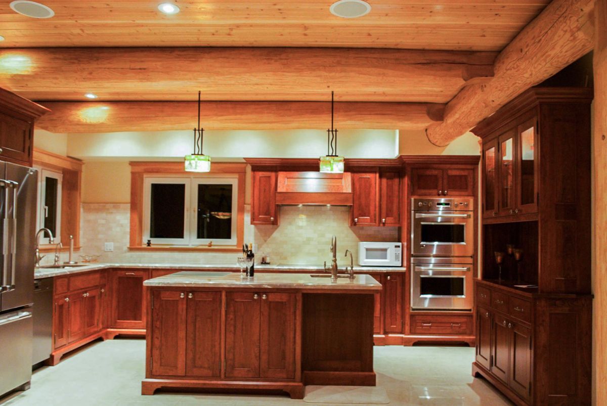 Custom Muskoka Cottage featuring a  kitchen with wooden cabinets and stainless steel appliances