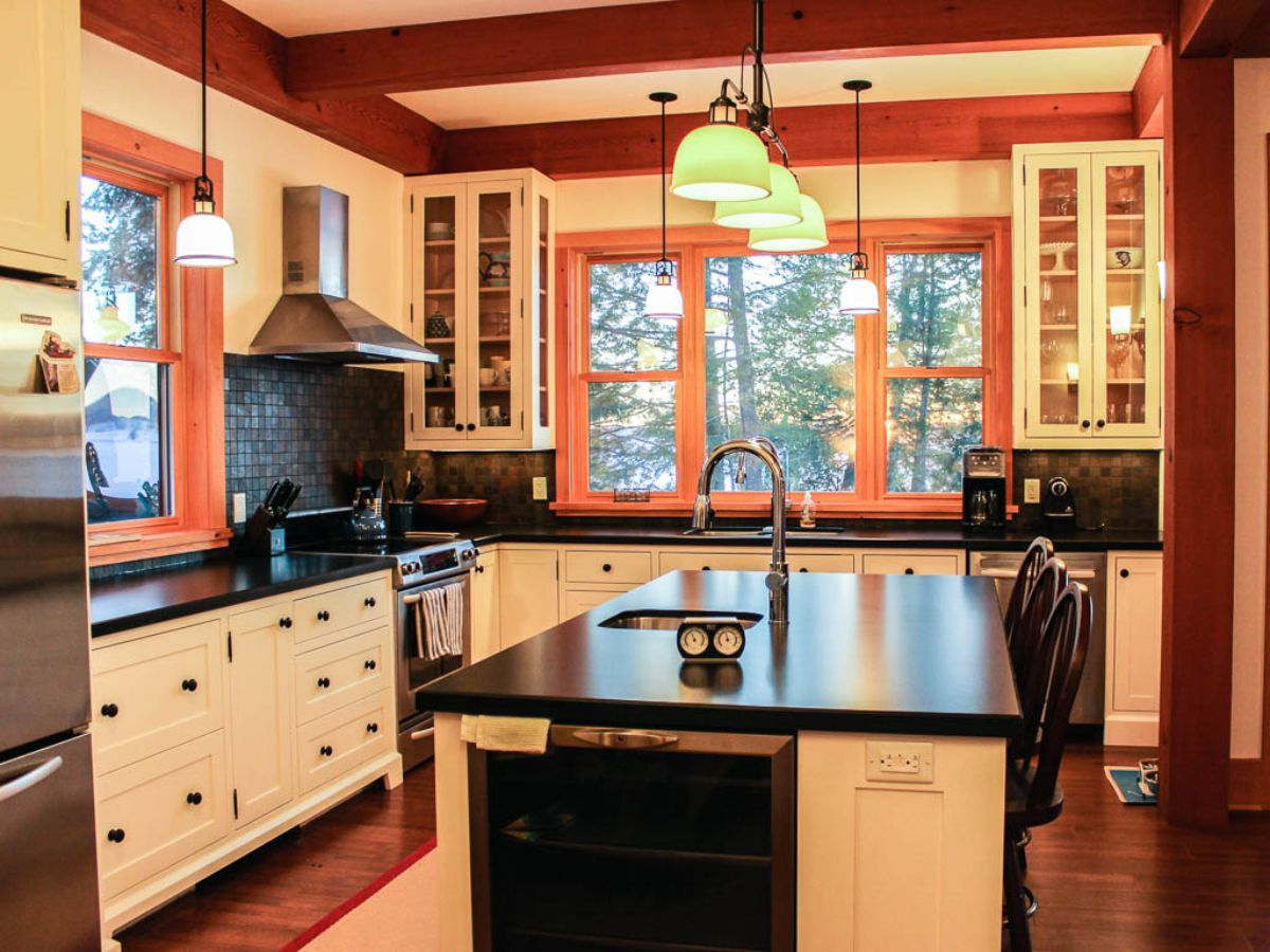 Custom Muskoka Cottage featuring a  kitchen with white cabinets and stainless steel appliances