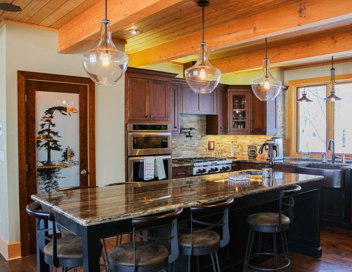 Custom Muskoka Cottage featuring a  kitchen with a large island and stools