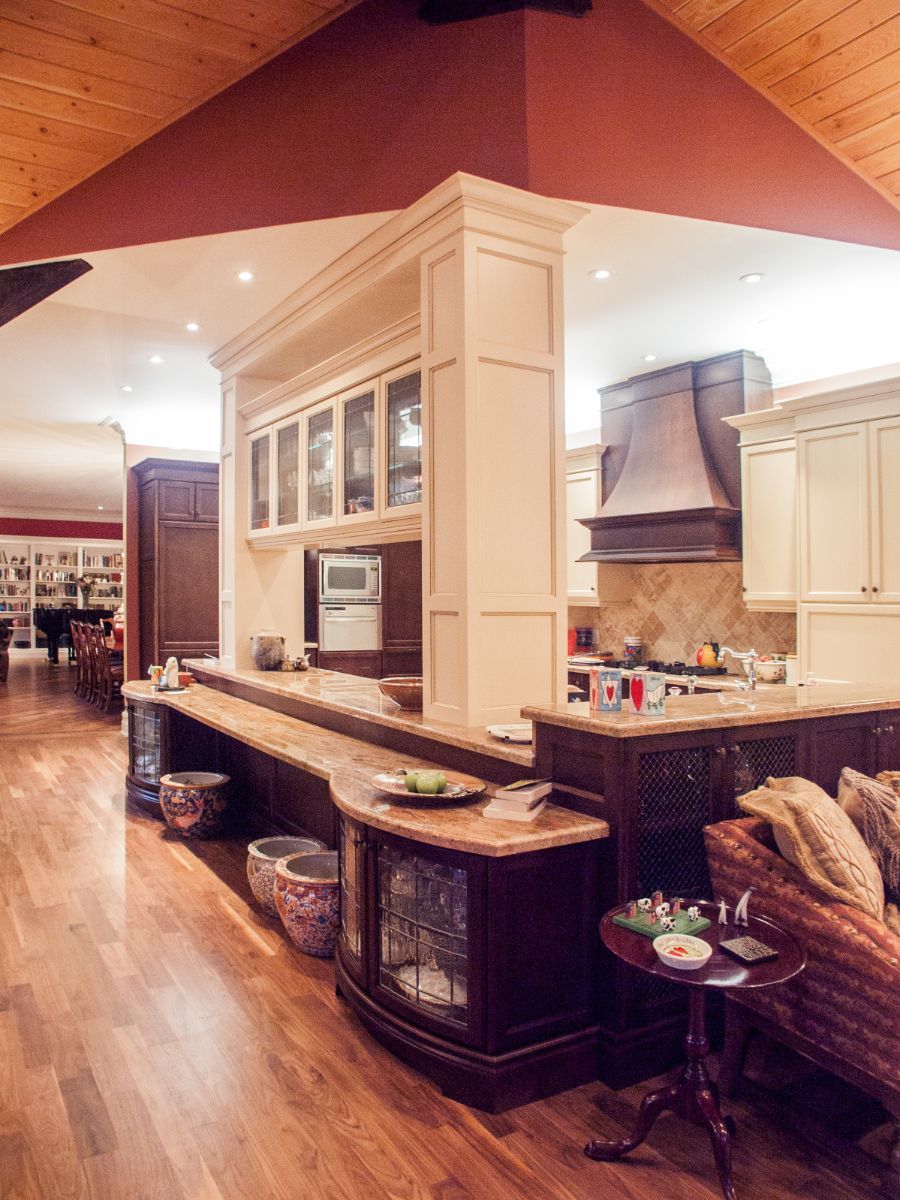 Custom Muskoka Cottage featuring a  kitchen with white cabinets and a wooden floor