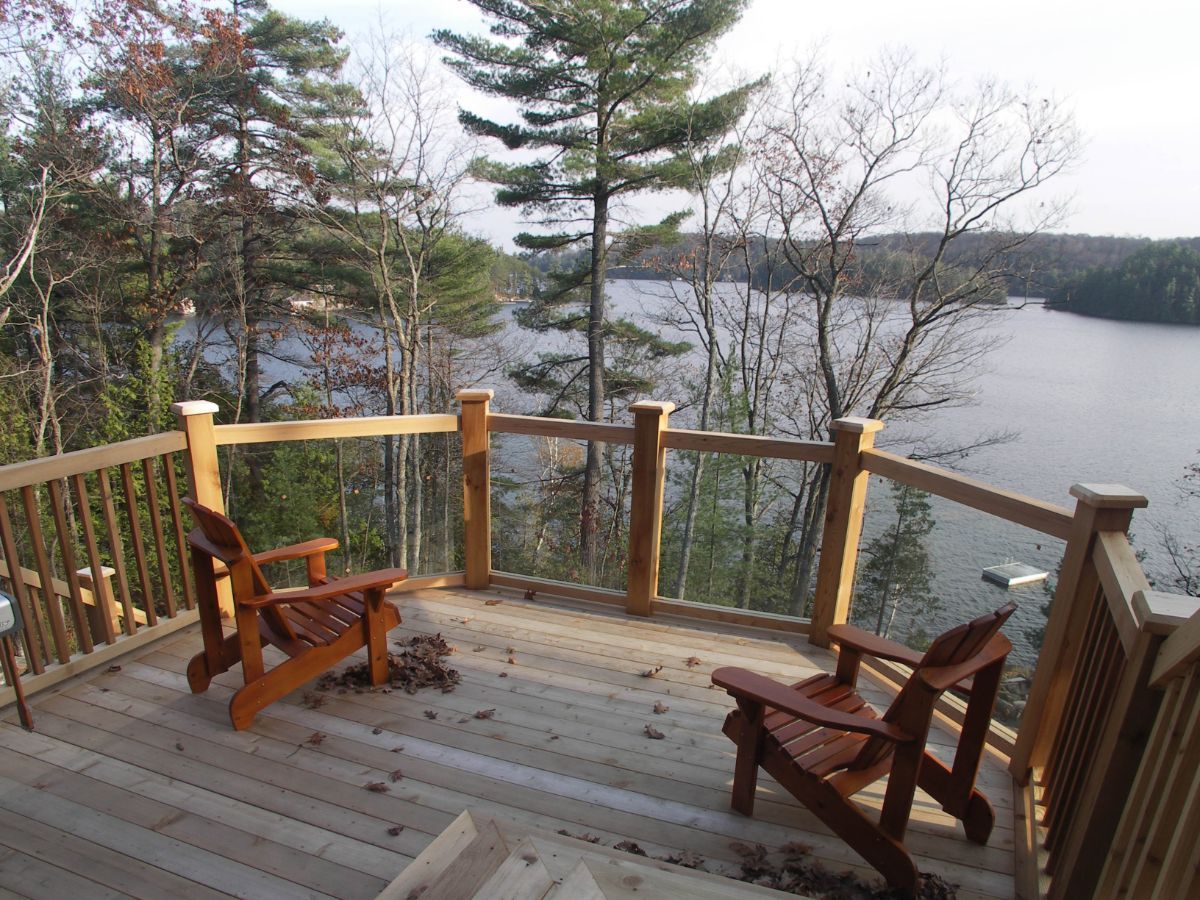 Two chairs on a deck overlooking Lake Muskoka