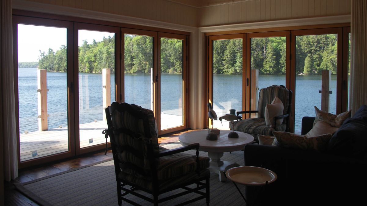 Custom Muskoka Cottage featuring a  living room with a view of a lake