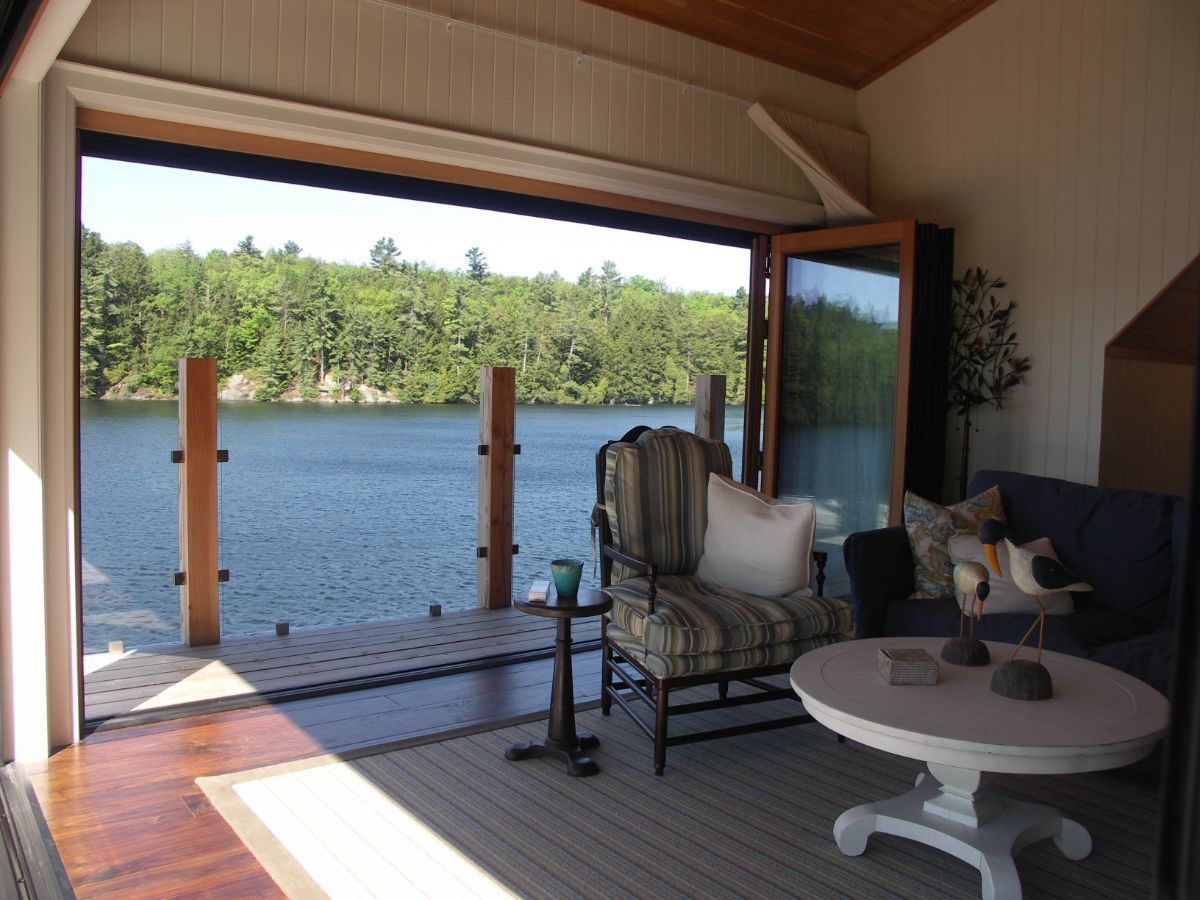 Custom Muskoka Cottage featuring a  living room with a view of a lake