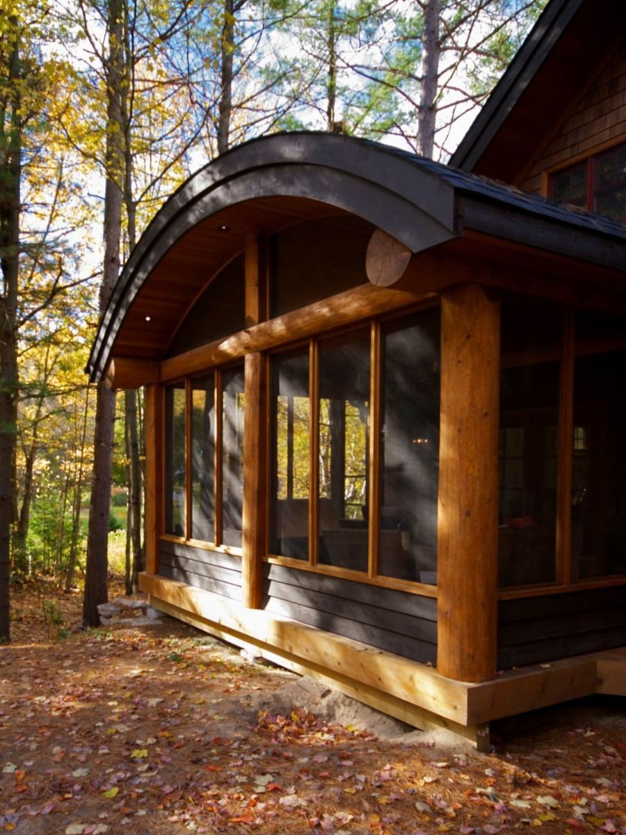 Custom Muskoka Cottage featuring a  house with a screened in porch in the woods