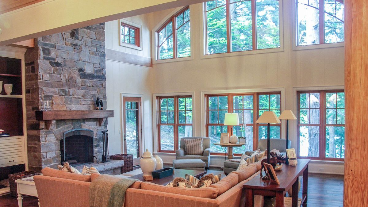 Custom Muskoka Cottage featuring a  living room filled with furniture and a fireplace.